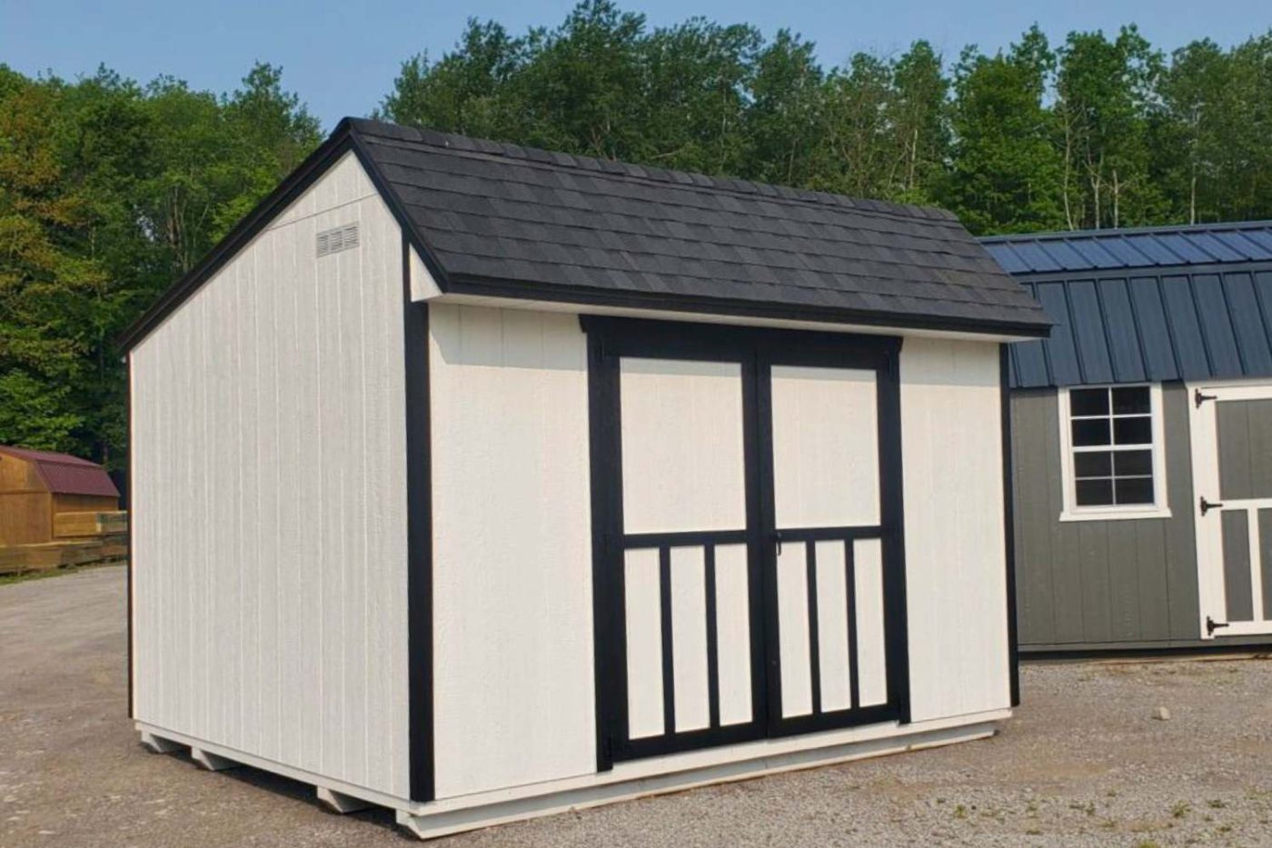 White and black 10x16 shed with shingle roof